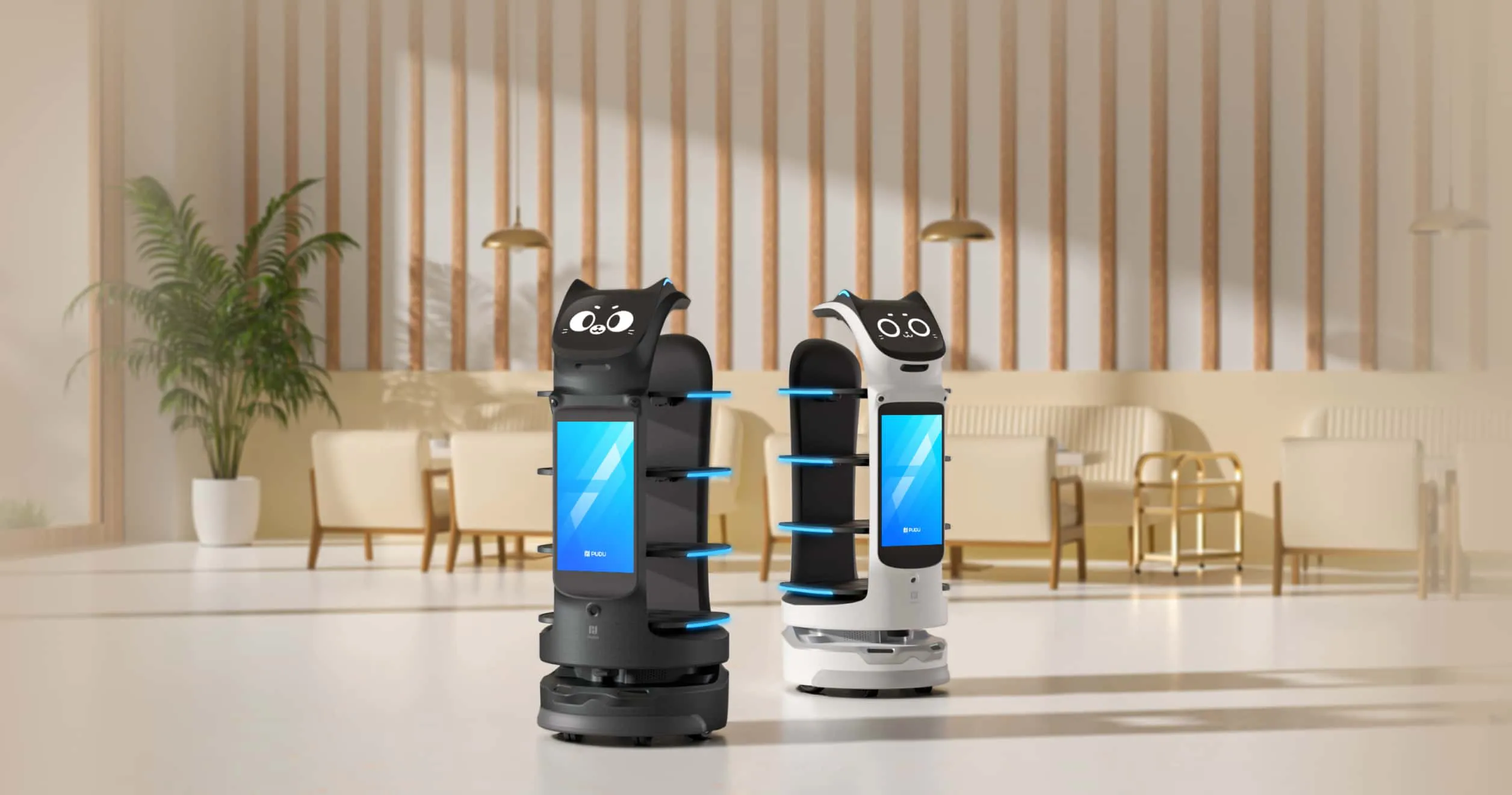 Restoran salonunda yan yana siyah ve beyaz iki BellaBot Pro servis robotu